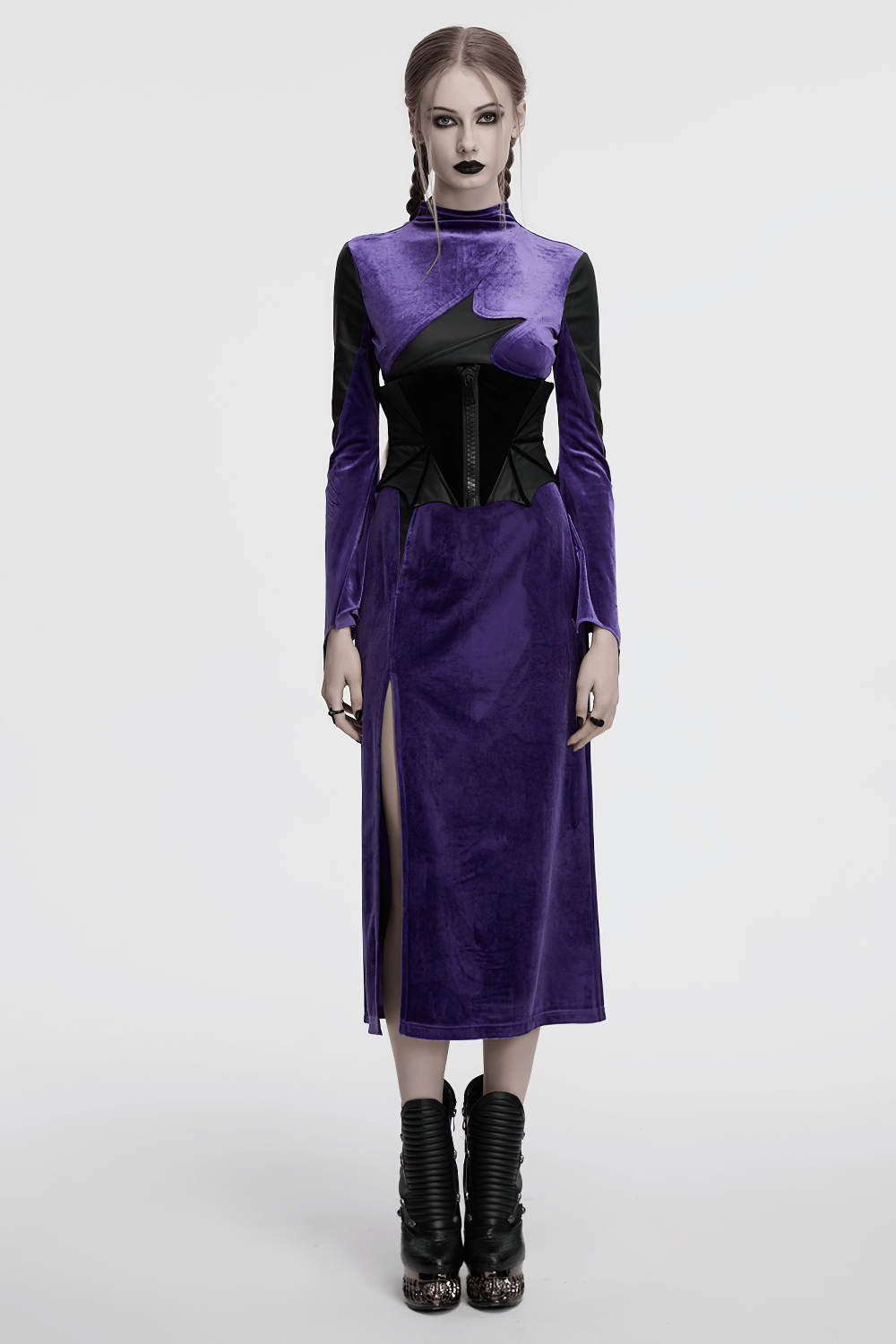 Model wearing a gothic purple velvet dress with a corset belt, showcasing dramatic style and unique design features.