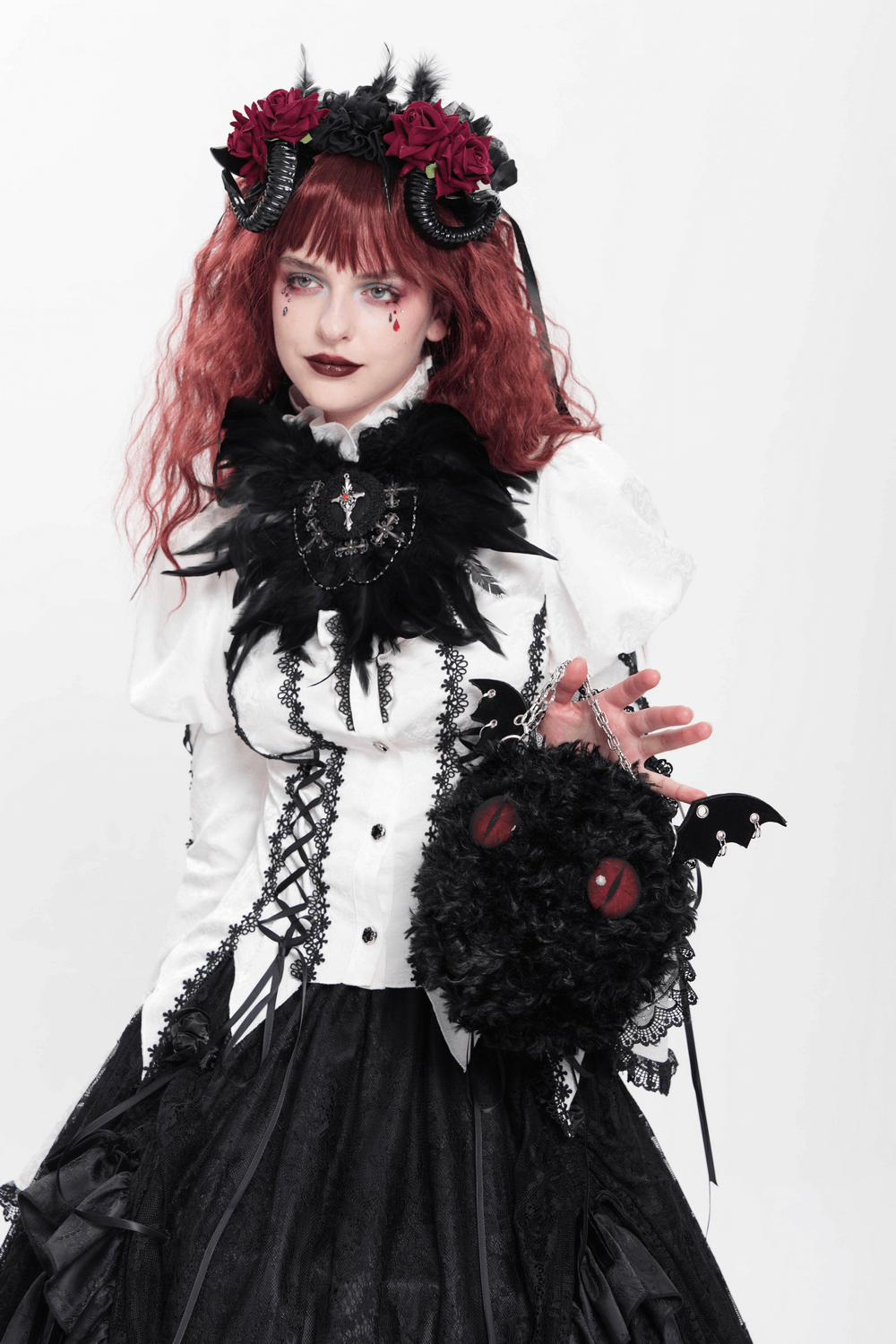 Model showcasing gothic bat wing plush shoulder bag with chains and red eyes in stylish alternative outfit.