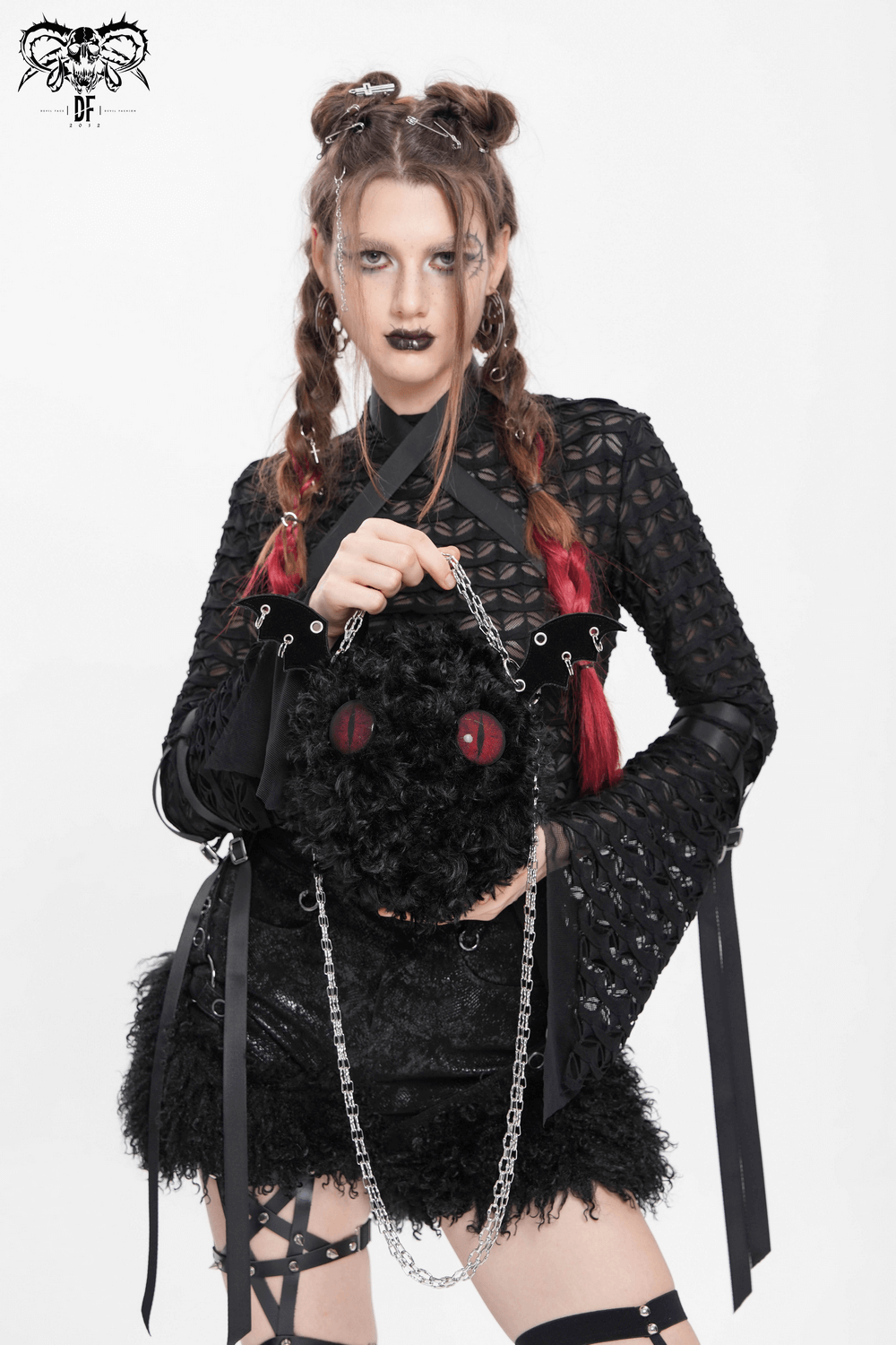 Model showcasing a Gothic bat wing plush shoulder bag with chains and red eyes, perfect for alternative fashion.