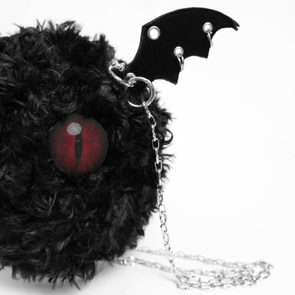 Gothic bat wing plush shoulder bag with red eye and chains, perfect for alternative fashion and spooky style.