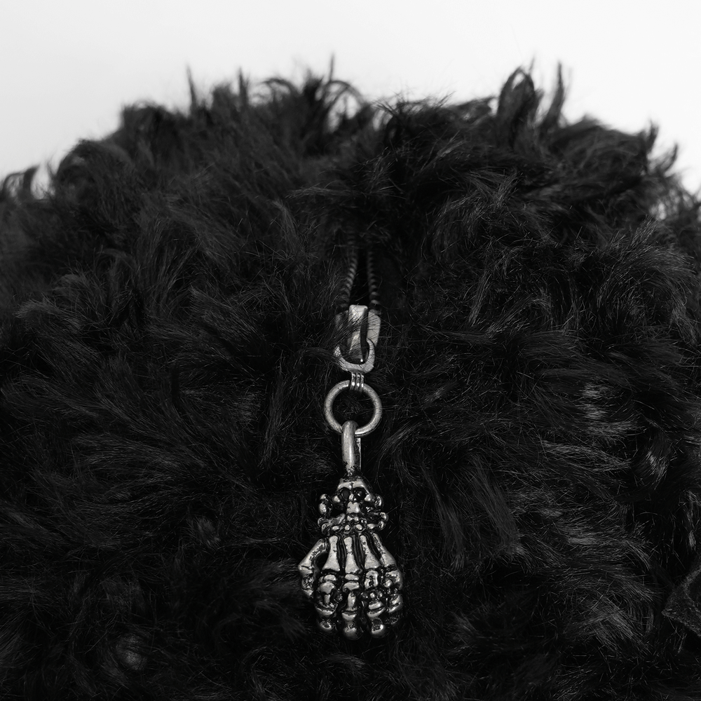 Close-up of black plush bag showing zipper with skeleton hand charm, perfect for gothic and punk fashion.