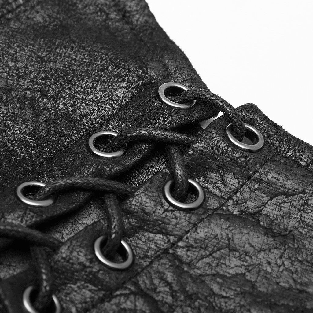 Close-up of gothic batwing cape showing cracked PU leather texture and metal eyelets with black lace.