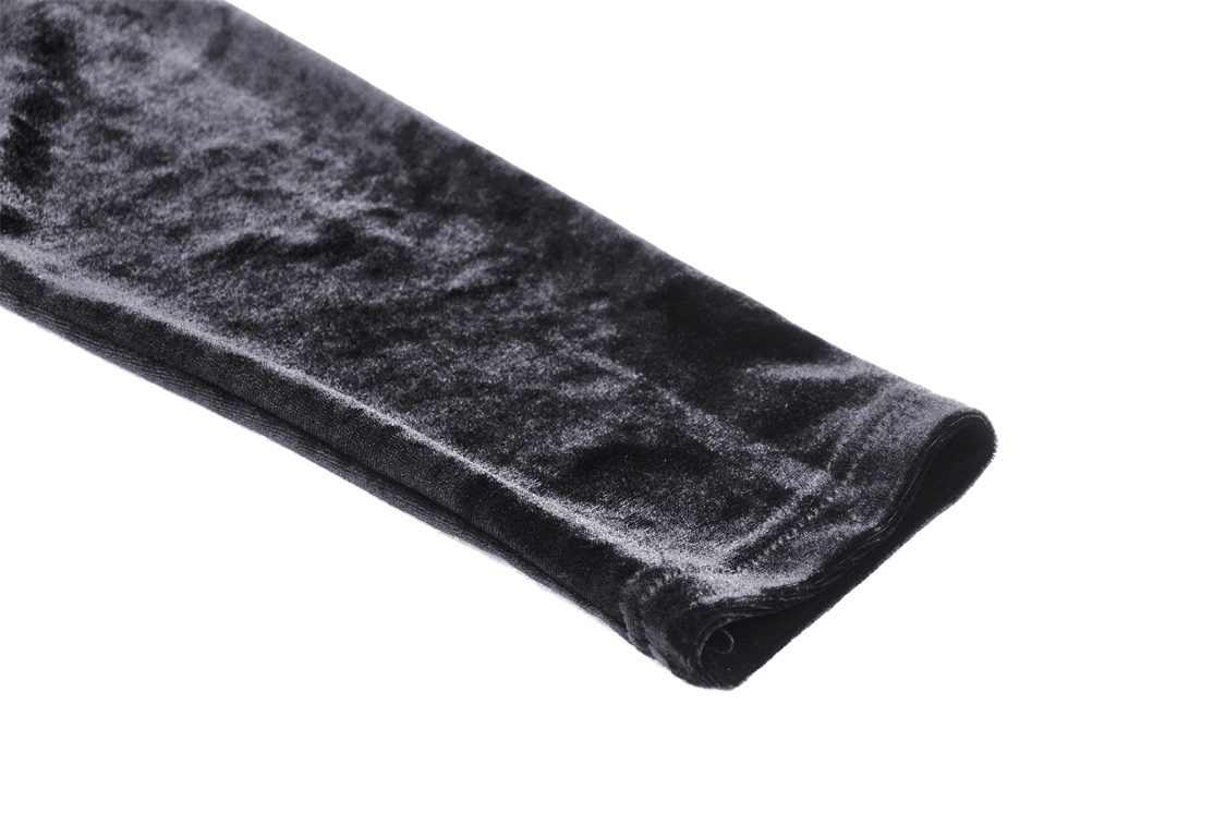Close-up of the soft black velvet fabric of a batwing hoodie sleeve.