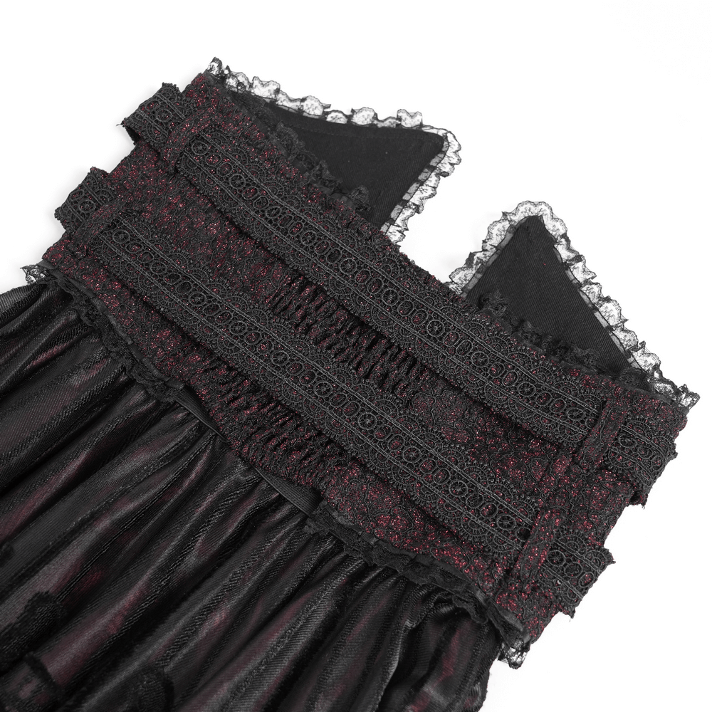 Close-up of the lace waistband and detailing on a gothic black and burgundy maxi skirt.