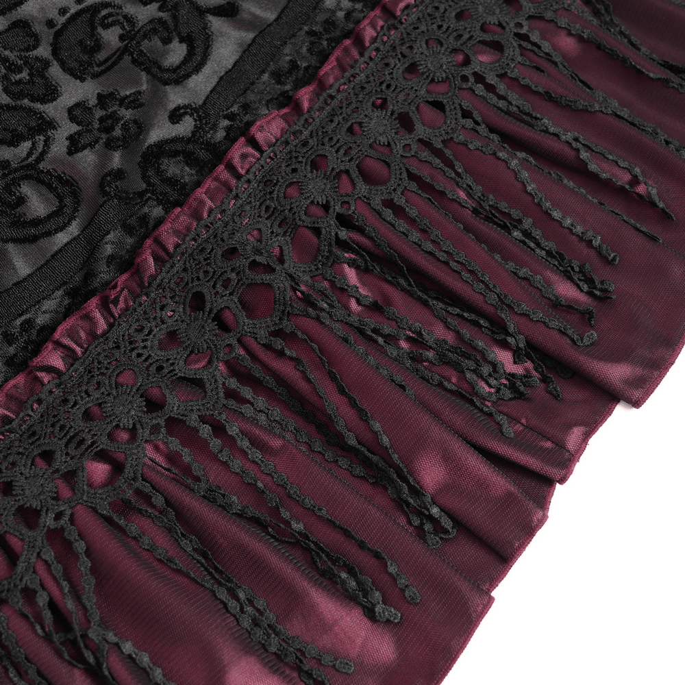 Close-up of gothic black and burgundy maxi skirt lace hem, showcasing intricate detailing and flowing fabric.