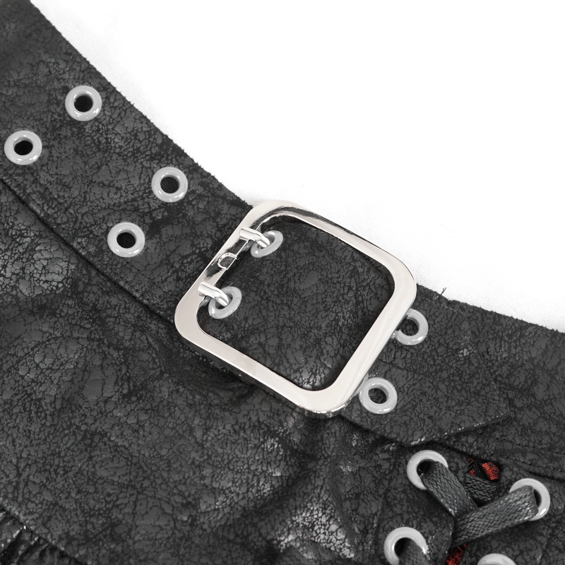 Close-up of black leather skirt buckle detail with metal accents and eyelets.