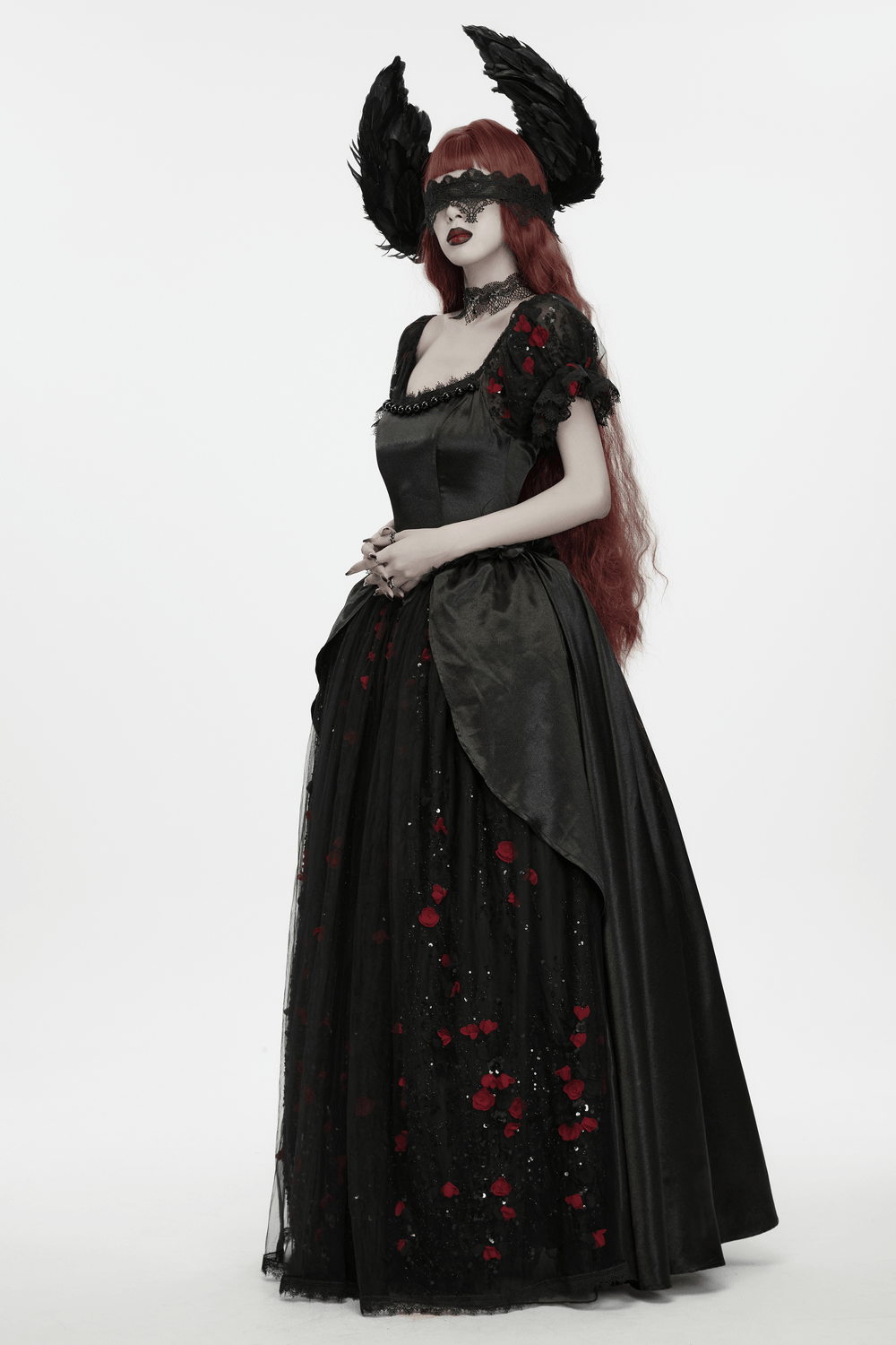 A model wearing a Gothic Black Angel Feather Wing Lace Headband with a dark gown featuring floral details.