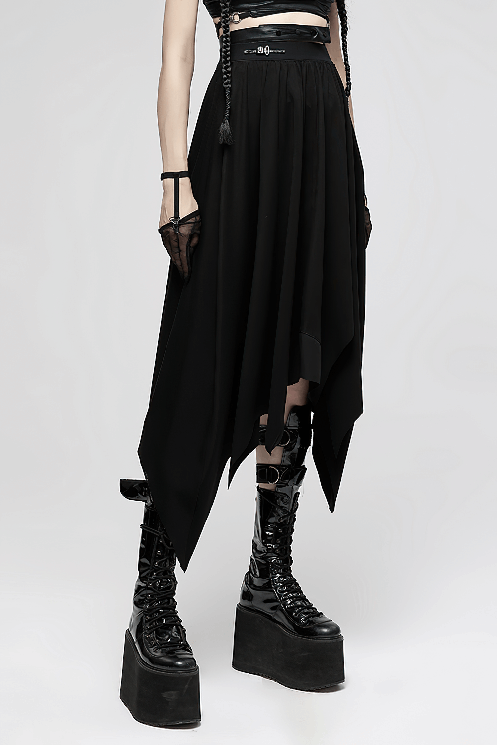 Gothic black asymmetrical long skirt with buckle waist and bat hem, paired with platform boots for edgy style.