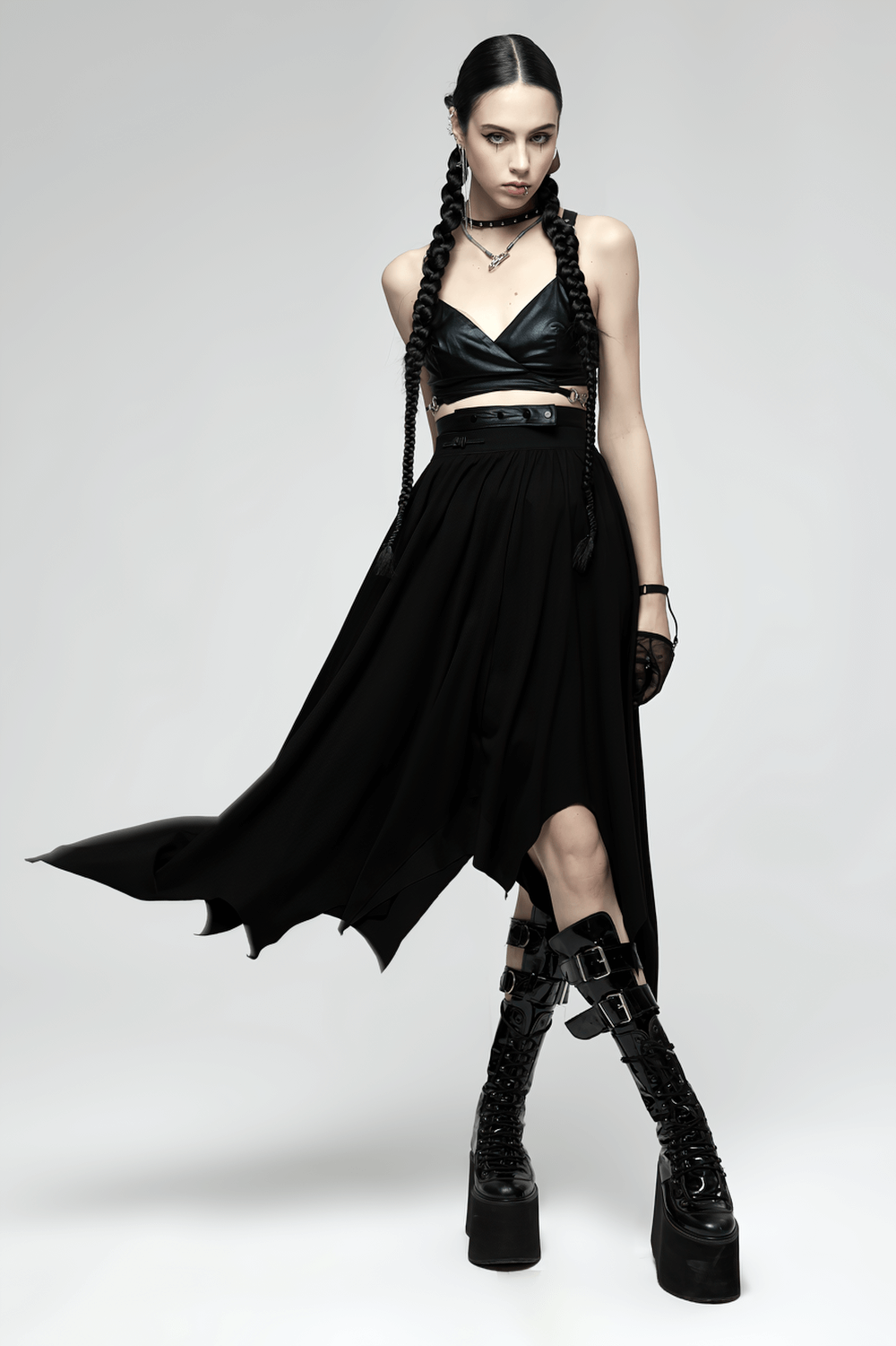 Model wearing gothic black asymmetrical long skirt with buckle waist, showcasing a dramatic bat hem and edgy style.