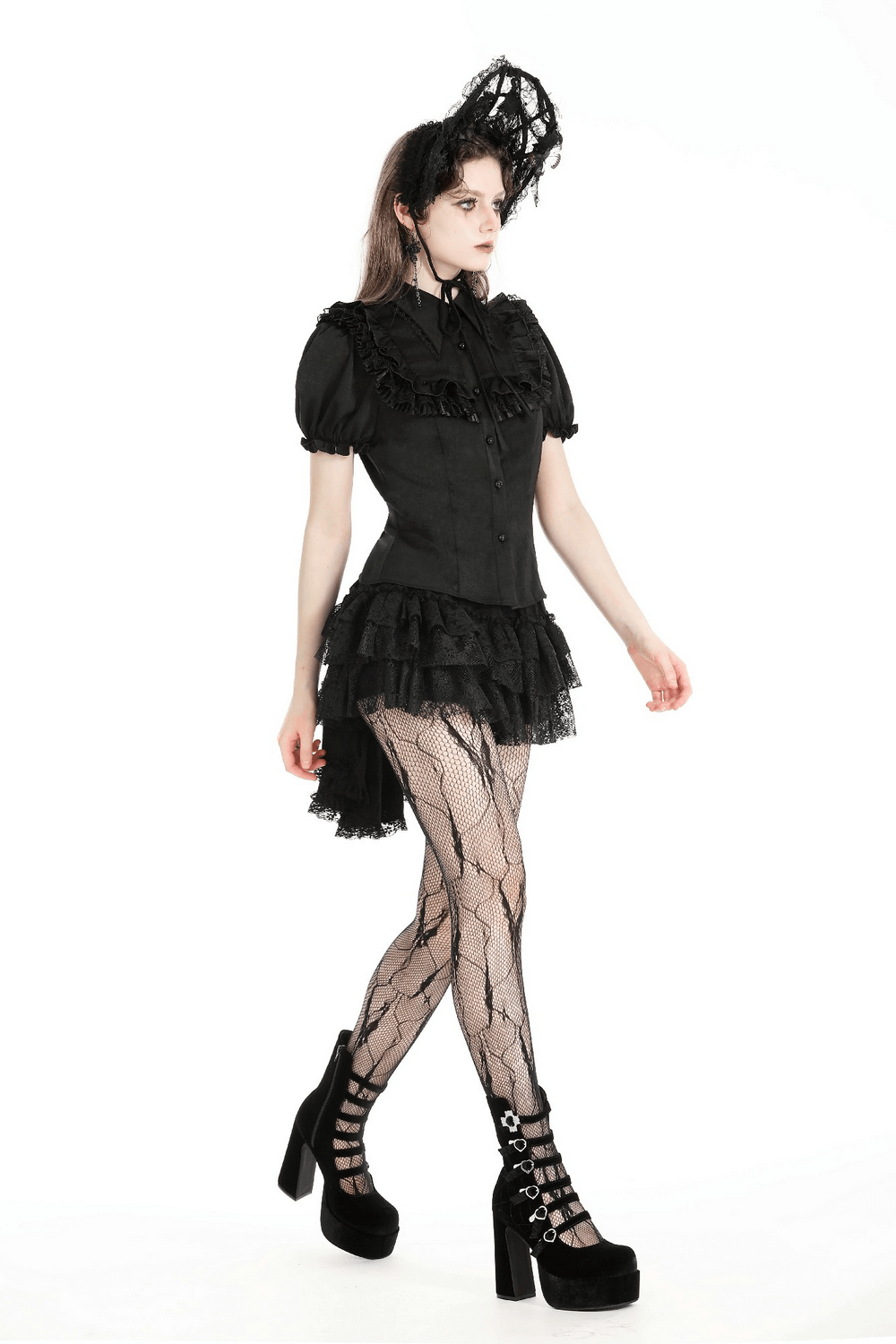 Victorian-inspired gothic black blouse with ruffles and puff sleeves, styled with fishnet tights and platform heels.