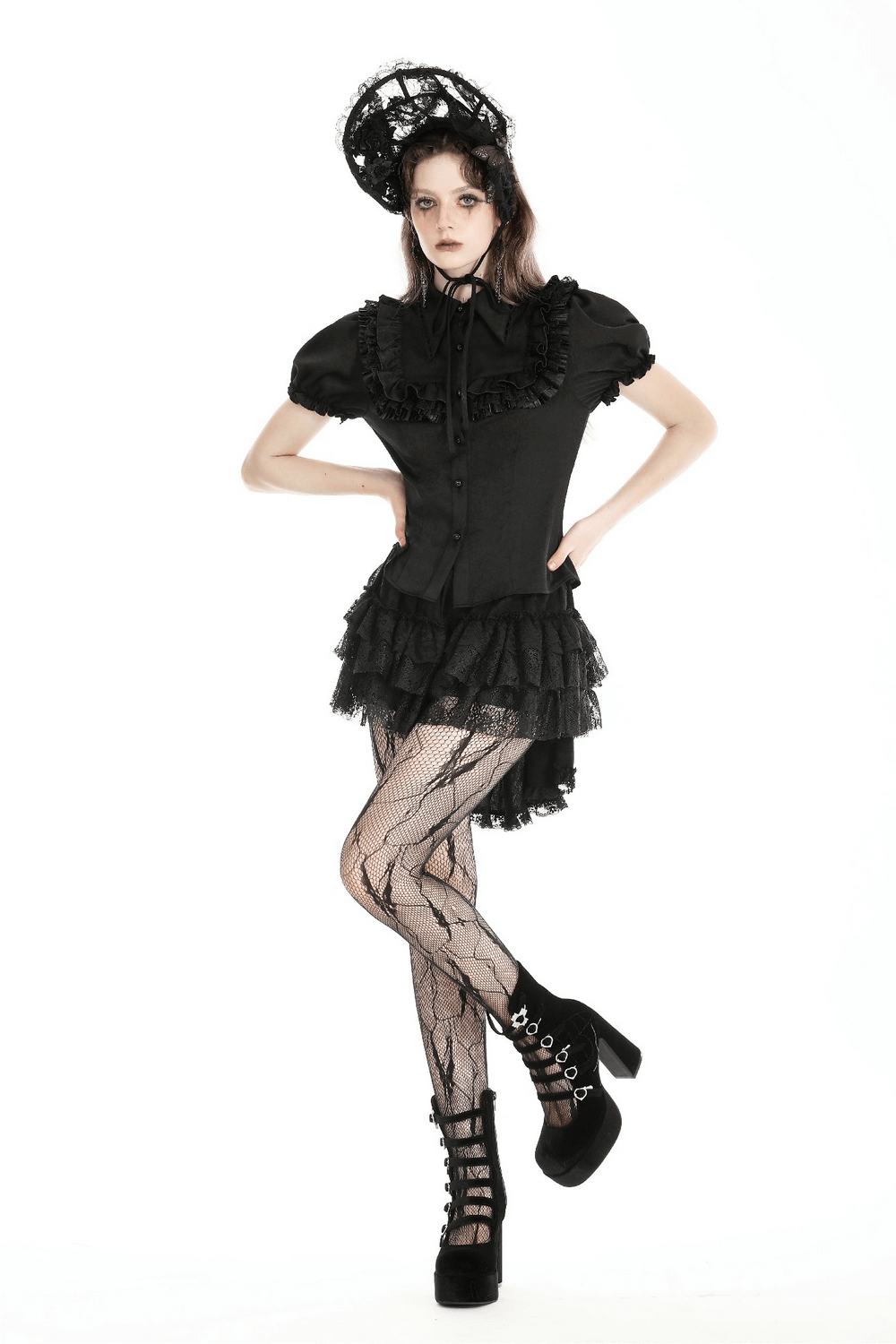 Gothic black blouse with puff sleeves and ruffle detail, paired with stylish black platform shoes and patterned tights.