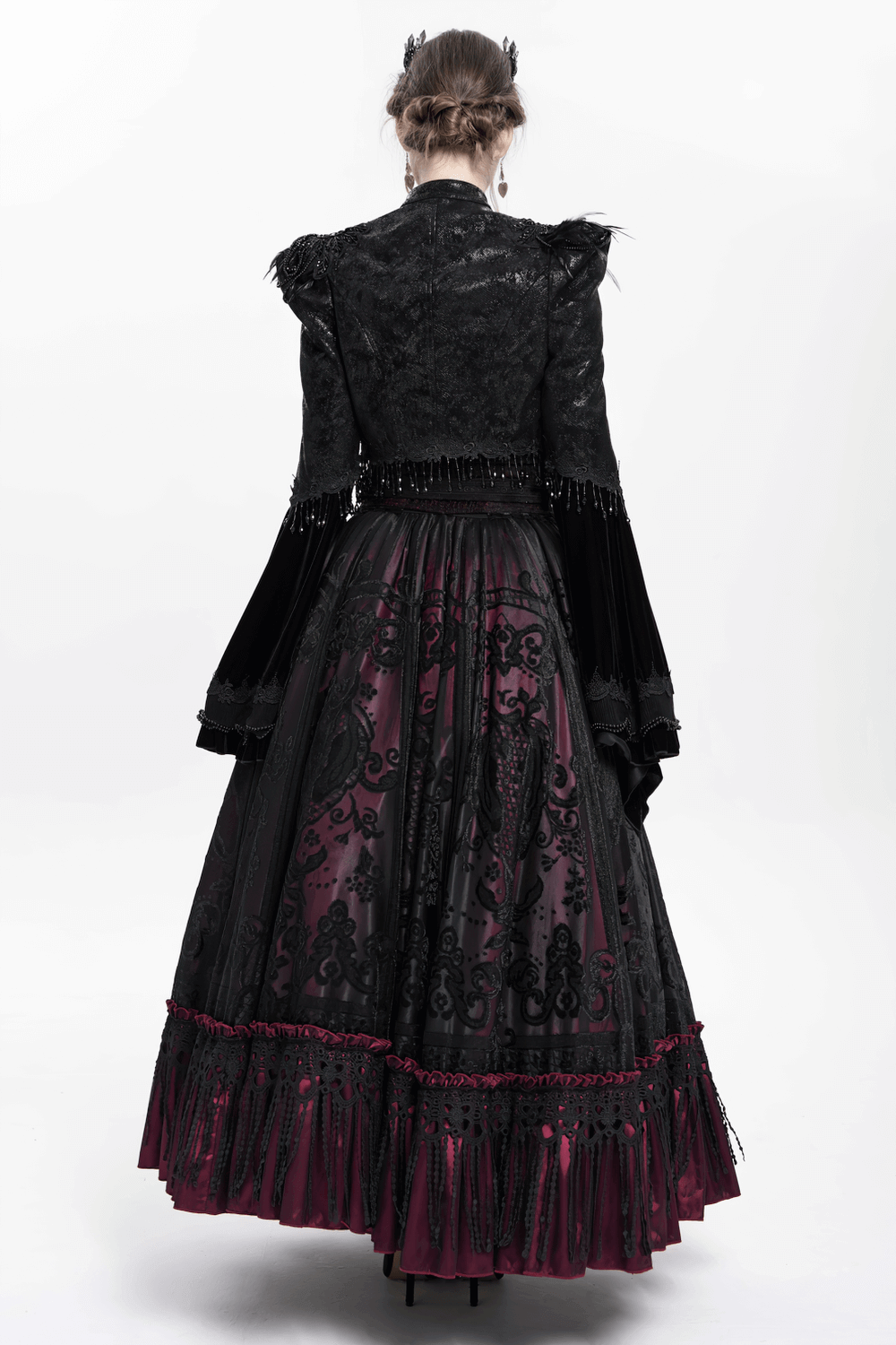 Back view of a gothic black bolero shrug with dramatic bell sleeves and a flowing dark skirt, perfect for Victorian style.