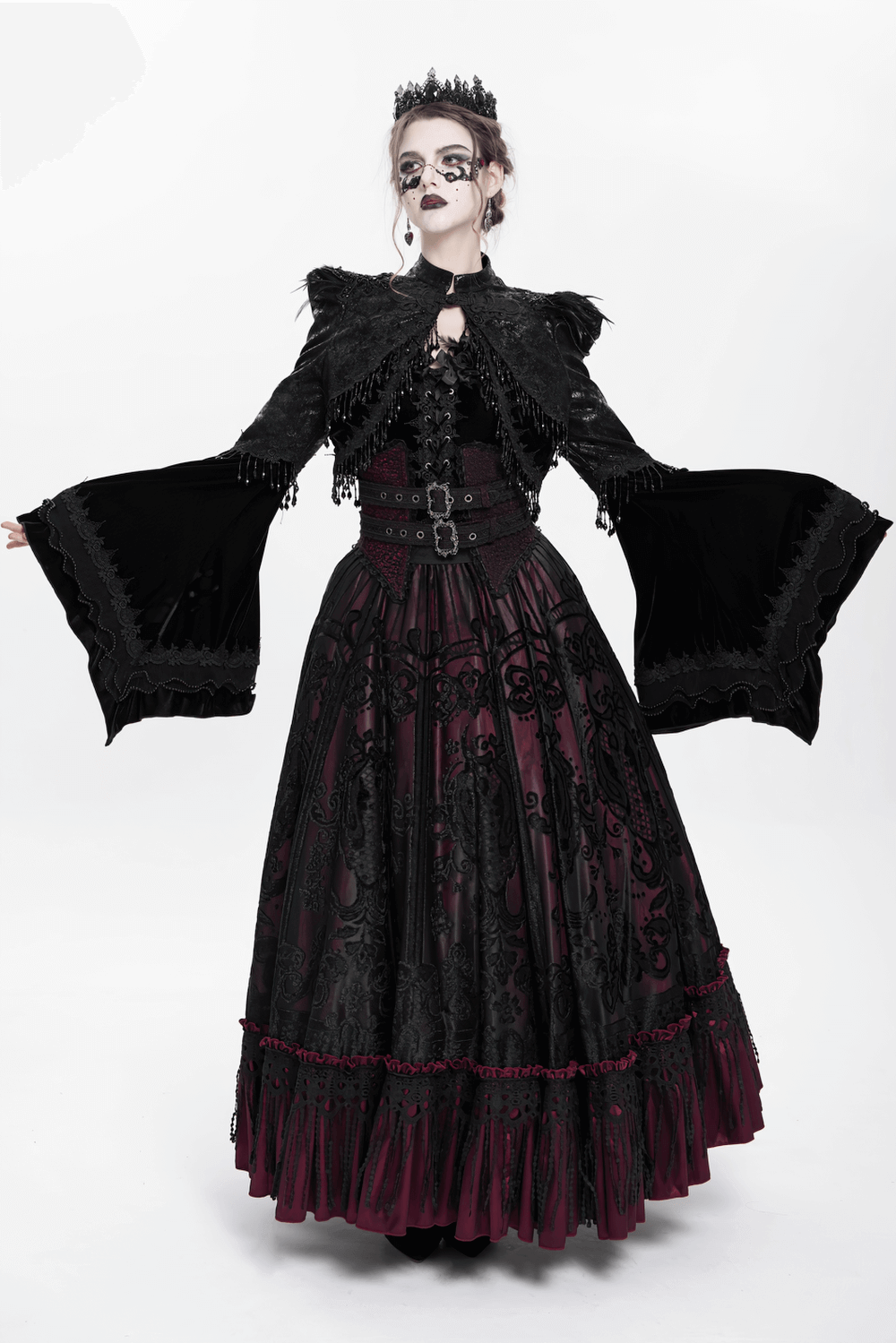 Victorian Gothic model in black bolero shrug and elegant dress with bell sleeves, showcasing dark elegance and style.