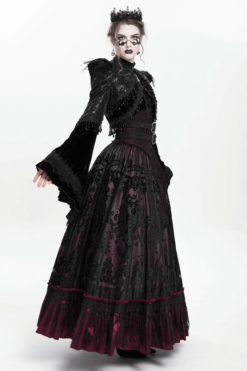 Gothic black bolero shrug with beaded bell sleeves, paired with an elegant Victorian gown for a dark, dramatic look.