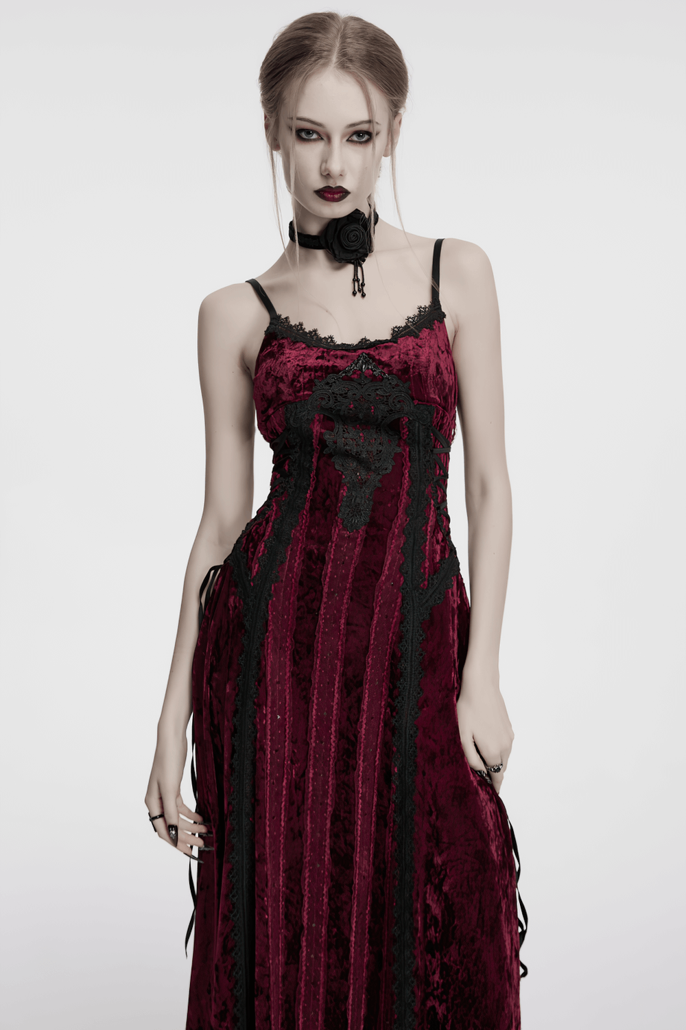 Model in a gothic black burning rose choker, wearing a crimson vintage lace dress with intricate details.