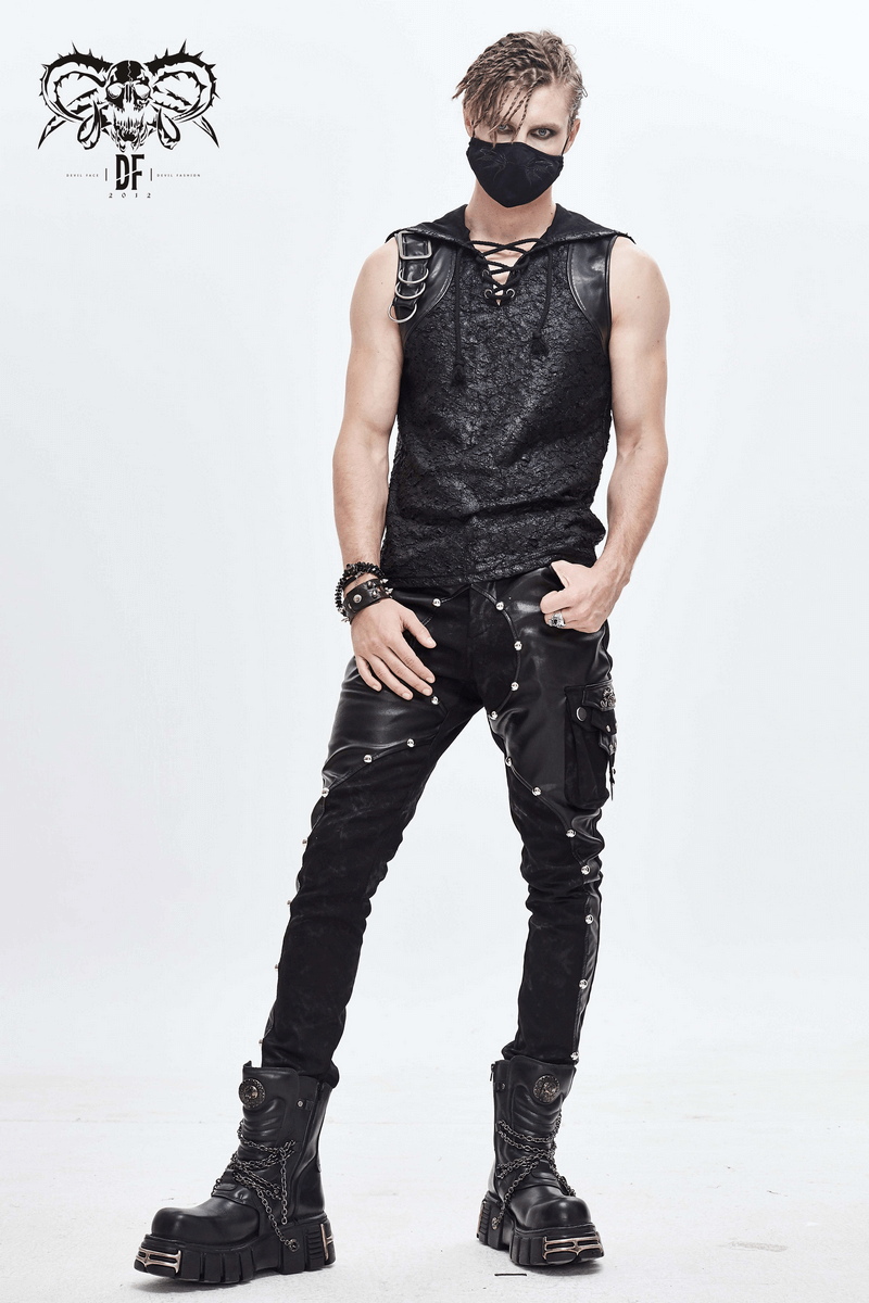 Gothic male model wearing a black butterfly face mask with a stylish outfit and chunky boots.