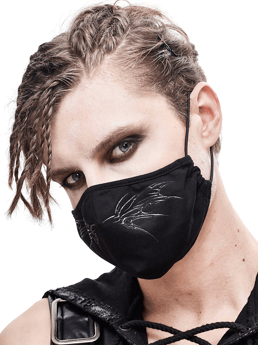 Stylish model wearing a gothic black butterfly face mask with adjustable bands, showcasing edgy fashion.