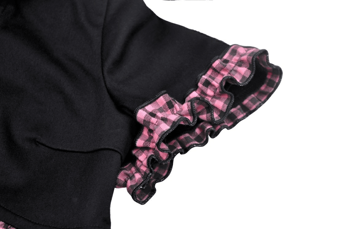 Detail of Gothic black cat ear crop top with pink plaid ruffled hem, showcasing stylish design elements.