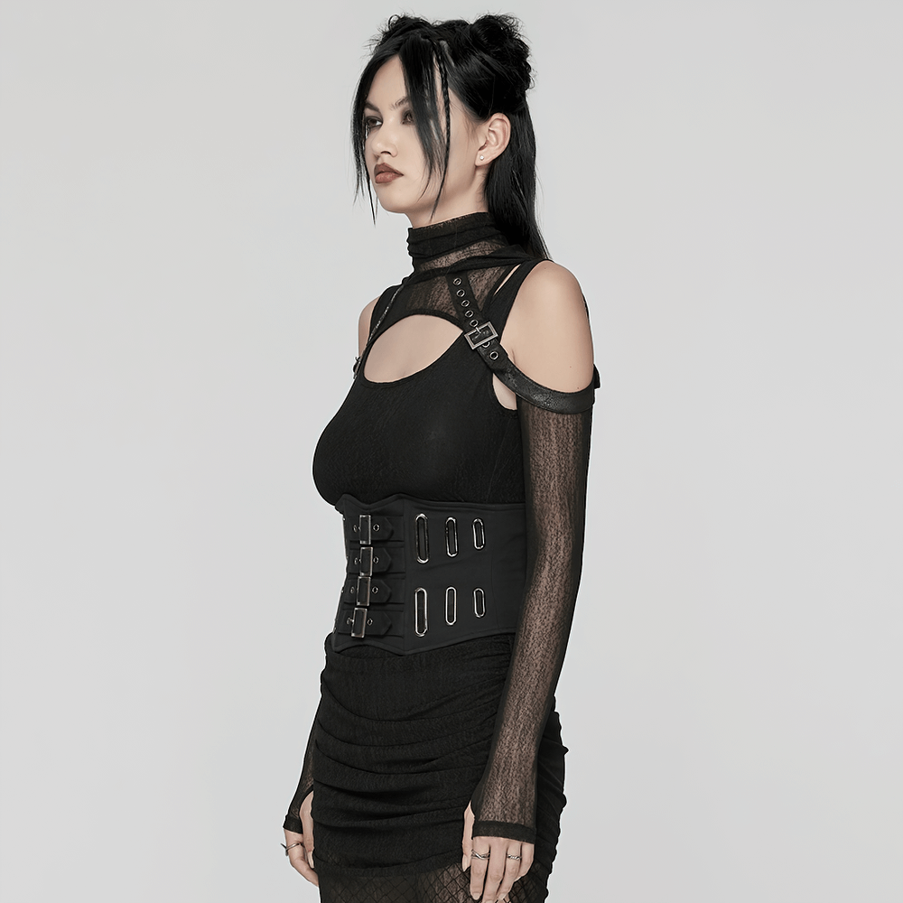 Gothic black corset belt with buckles and lace-up back worn by a model in a stylish edgy outfit.