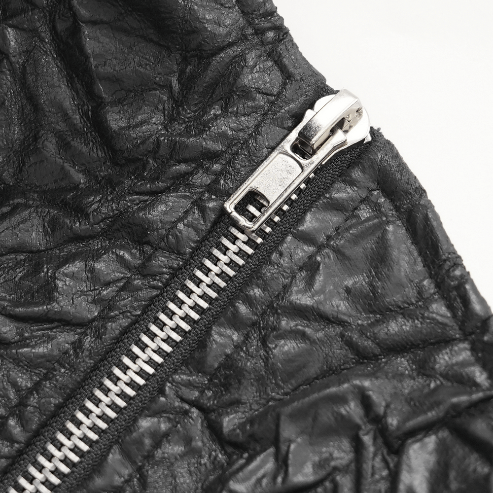 Close-up of the silver zipper on a gothic black crinkled leather kilt, showcasing its edgy punk rock style.