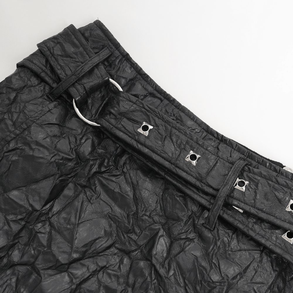 Close-up of gothic black crinkled leather kilt belt with buckles and detailing, perfect for punk rock fashion.