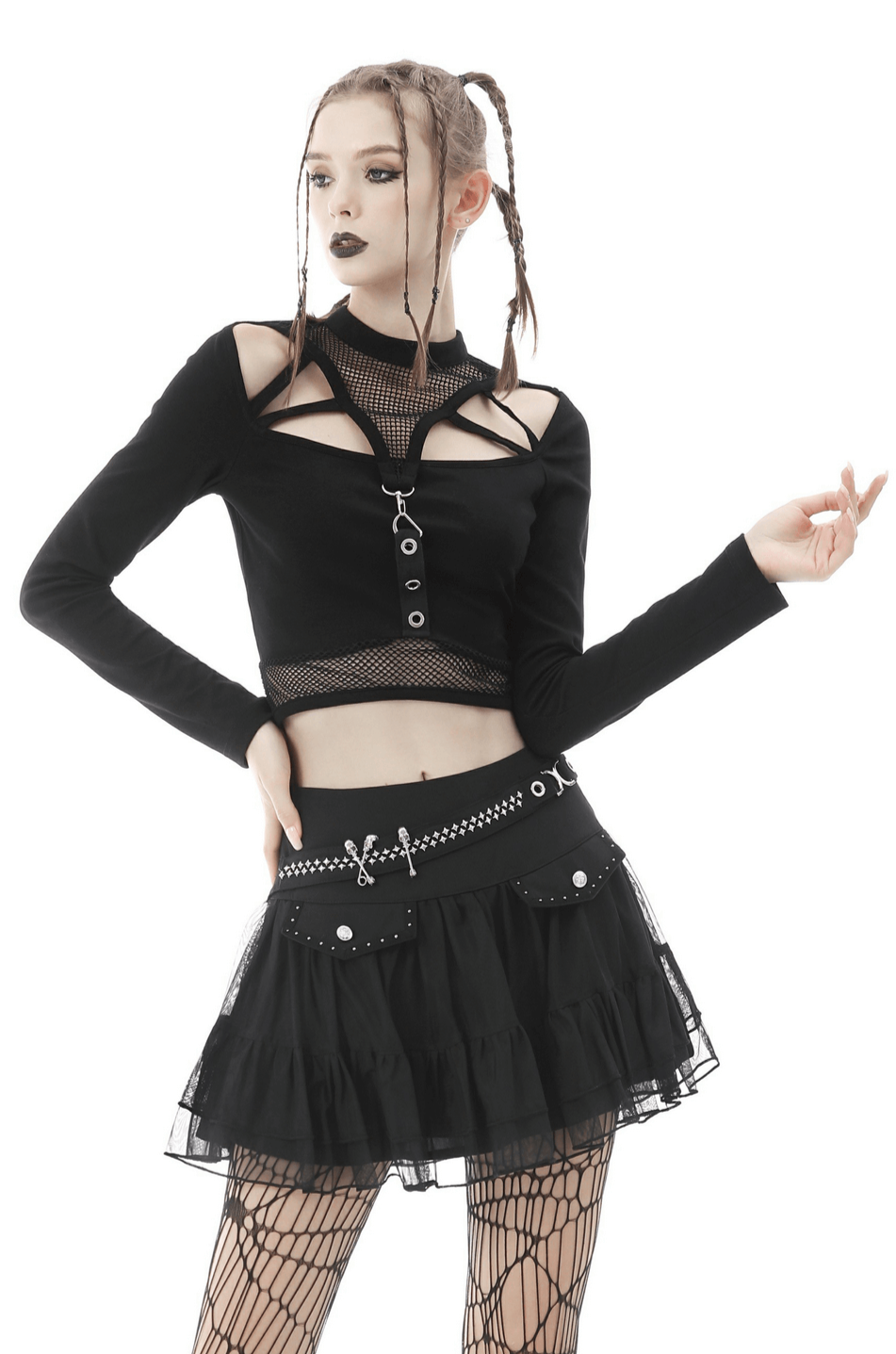 Gothic black crop top with mesh and straps, paired with a ruffled black skirt and fishnet stockings for an edgy look.