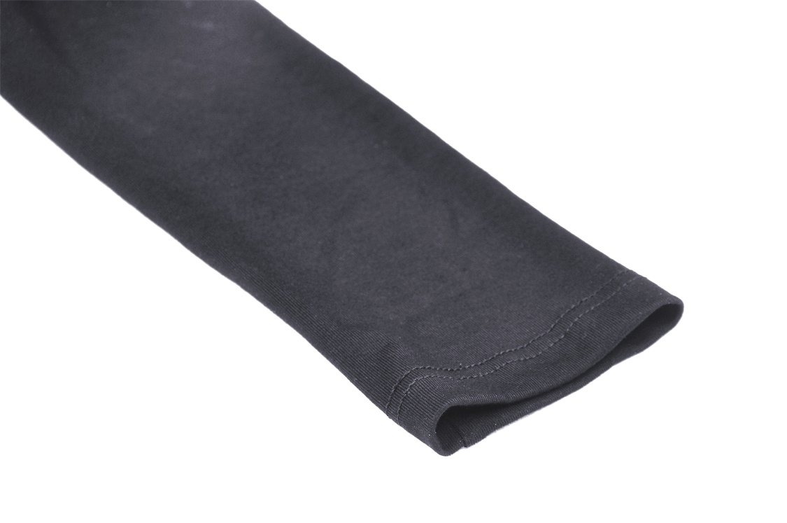 Close-up of the sleeve detail of a gothic black crop top with smooth fabric and seamless finish.