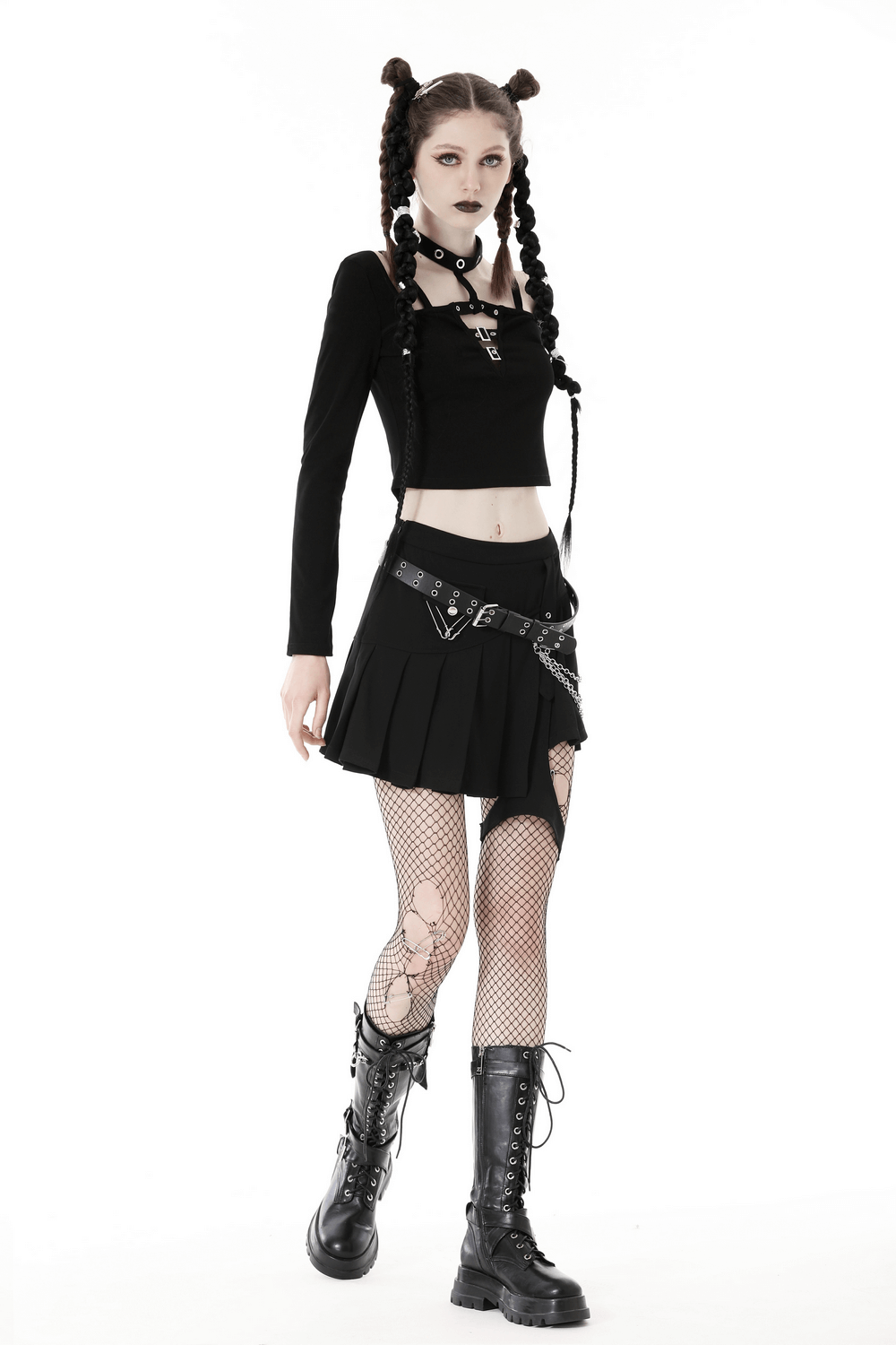 Gothic black crop top with metal accents, paired with a pleated skirt and fishnet stockings, showcasing edgy dark fashion.