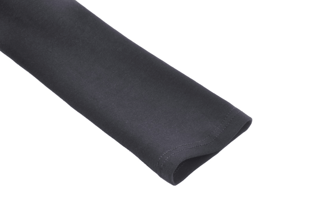 Close-up of the sleeve of a gothic black crop top featuring a smooth, dark fabric finish.