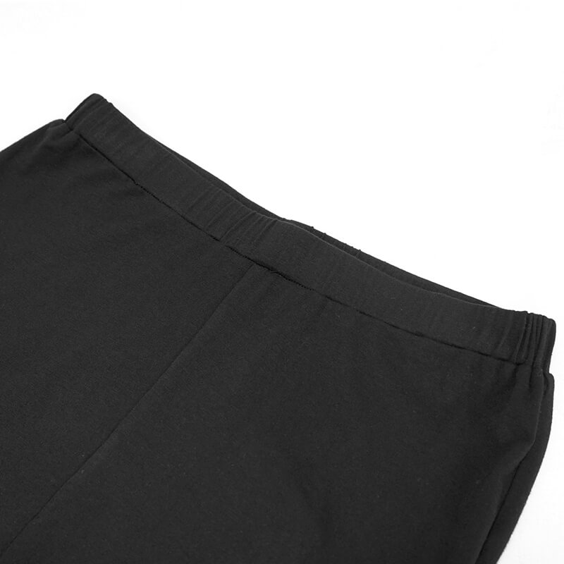 Close-up of the high waist band of gothic black lace bell-bottomed leggings for women.