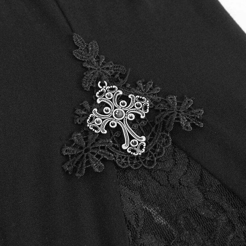 Close-up of lace detail and silver cross on gothic black leggings for women, showcasing elegant style.