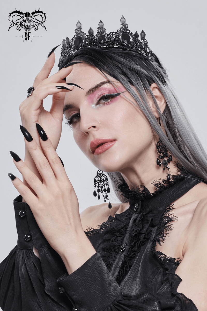 Elegant woman wearing a Gothic black crystal tiara, showcasing retro style with bold makeup and accessories.