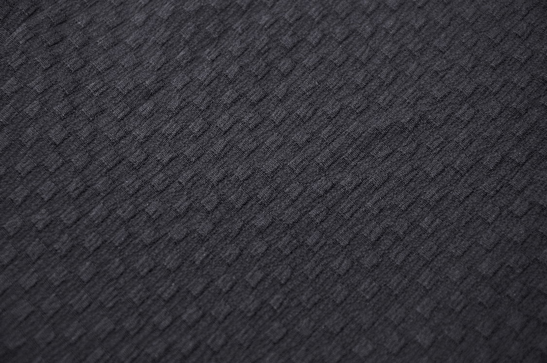 Close-up of textured black fabric showcasing a stylish and edgy design for gothic fashion.