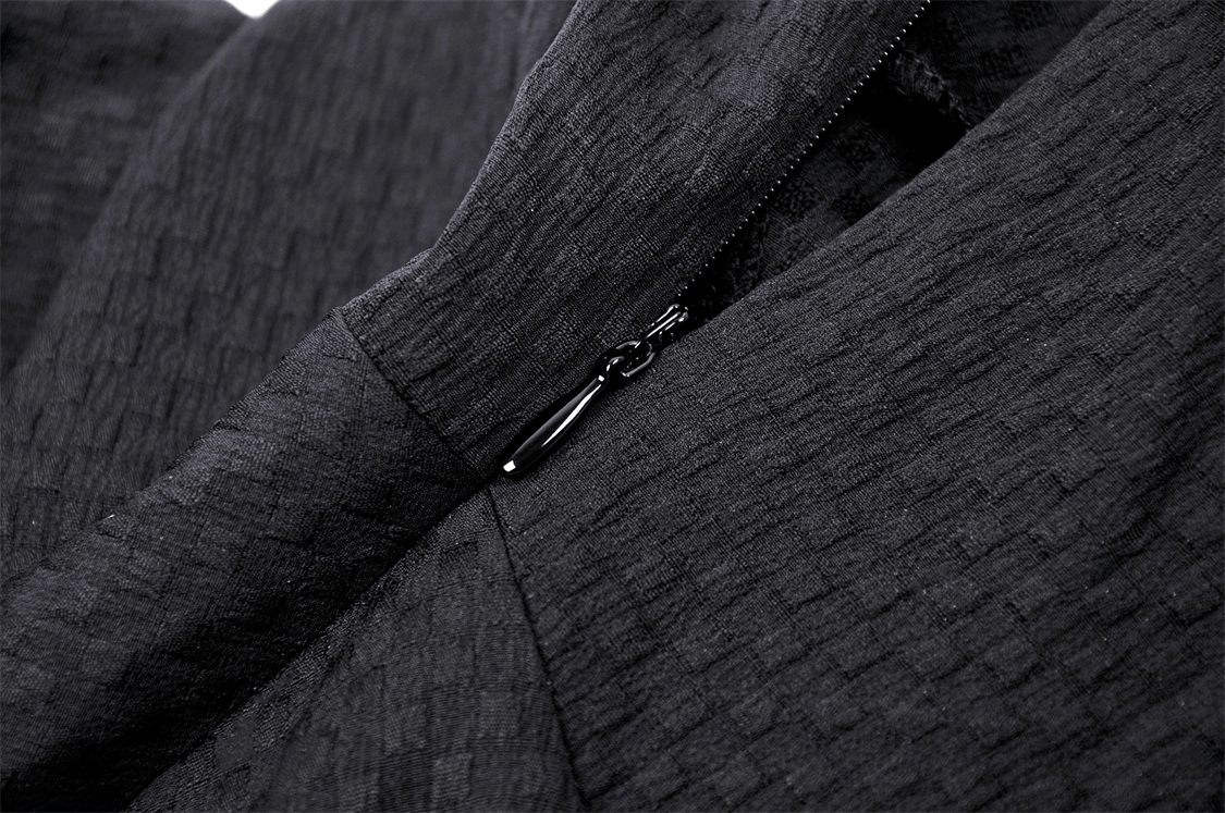 Close-up of a black dress fabric showing zip detail, perfect for gothic fashion lovers.