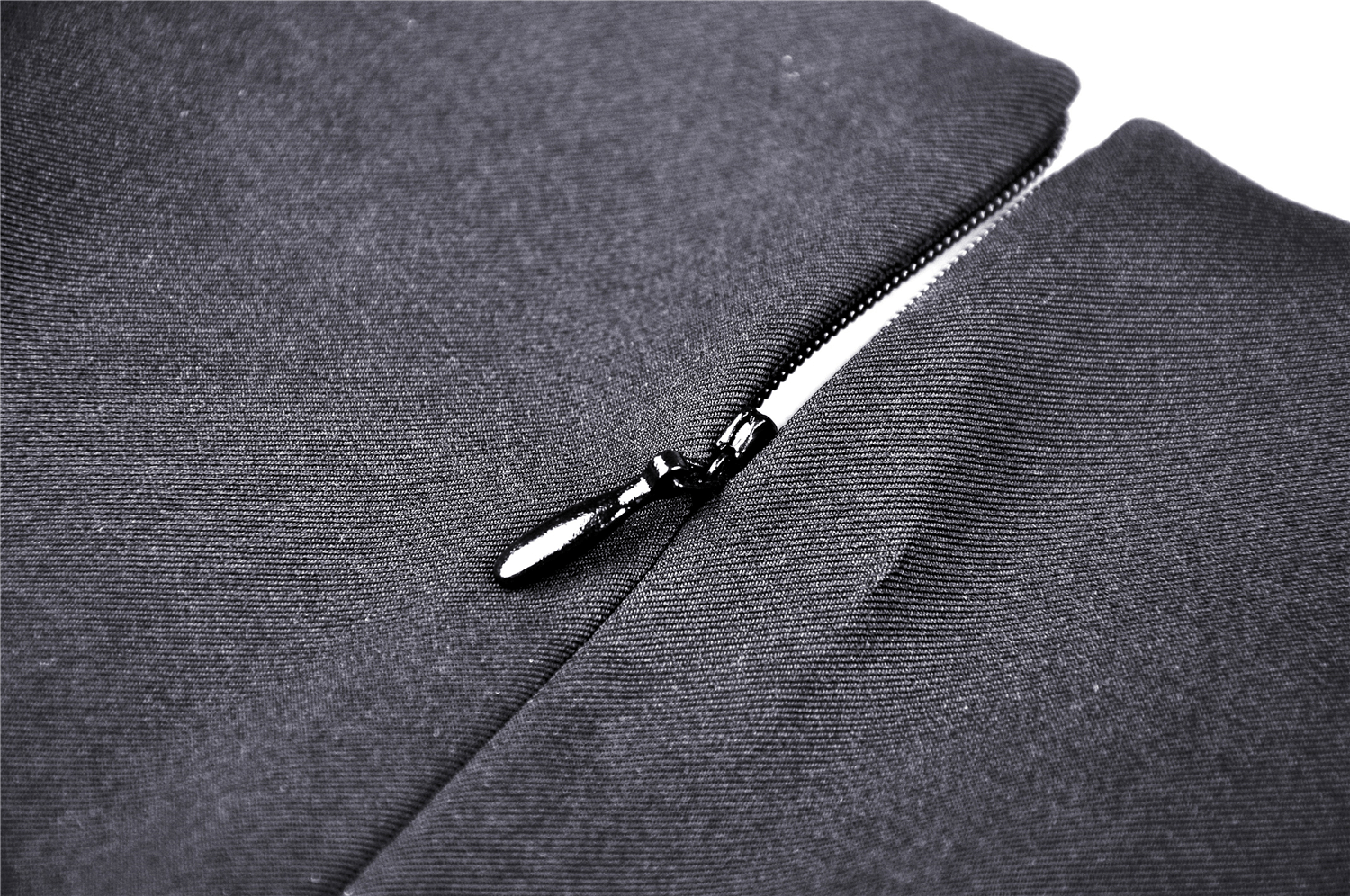 Close-up of a black zipper detail on a sleek fabric, perfect for gothic fashion pieces like mini dresses.