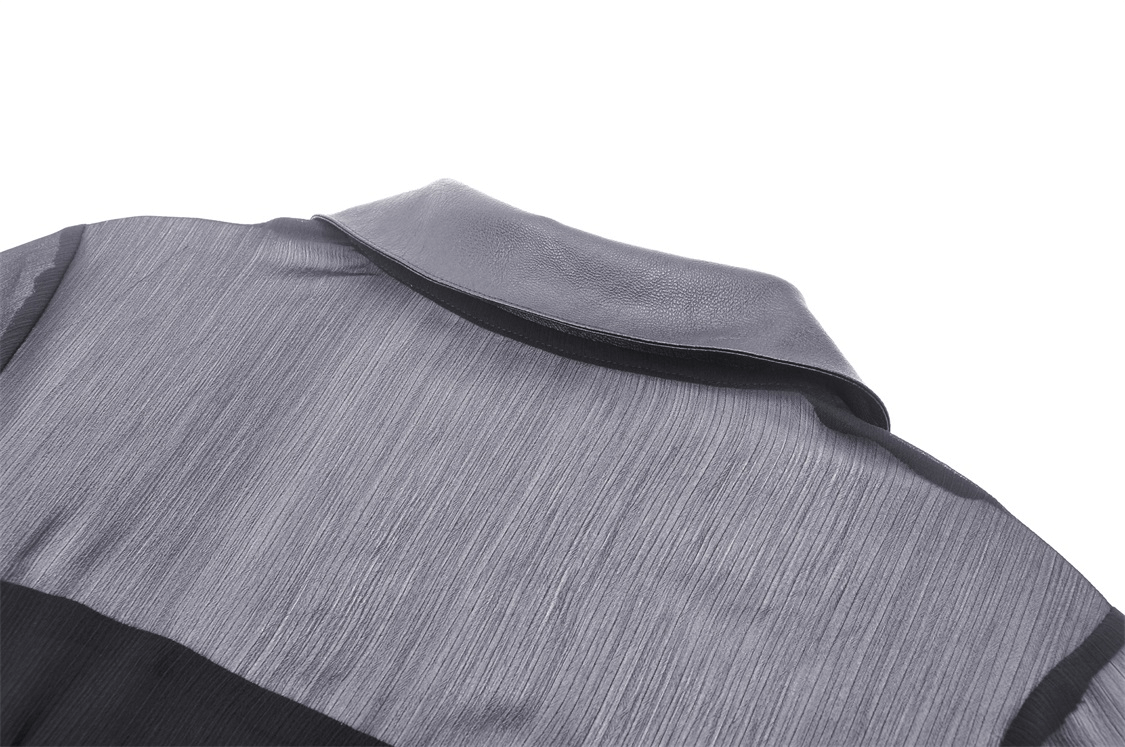 Close-up of the collar and patterned fabric on a Gothic-style dress with sleek grey tones.