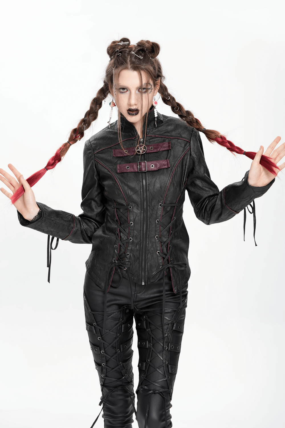 Gothic black faux leather jacket with buckles and lacing, worn by model with braided hair, showcasing edgy punk fashion.