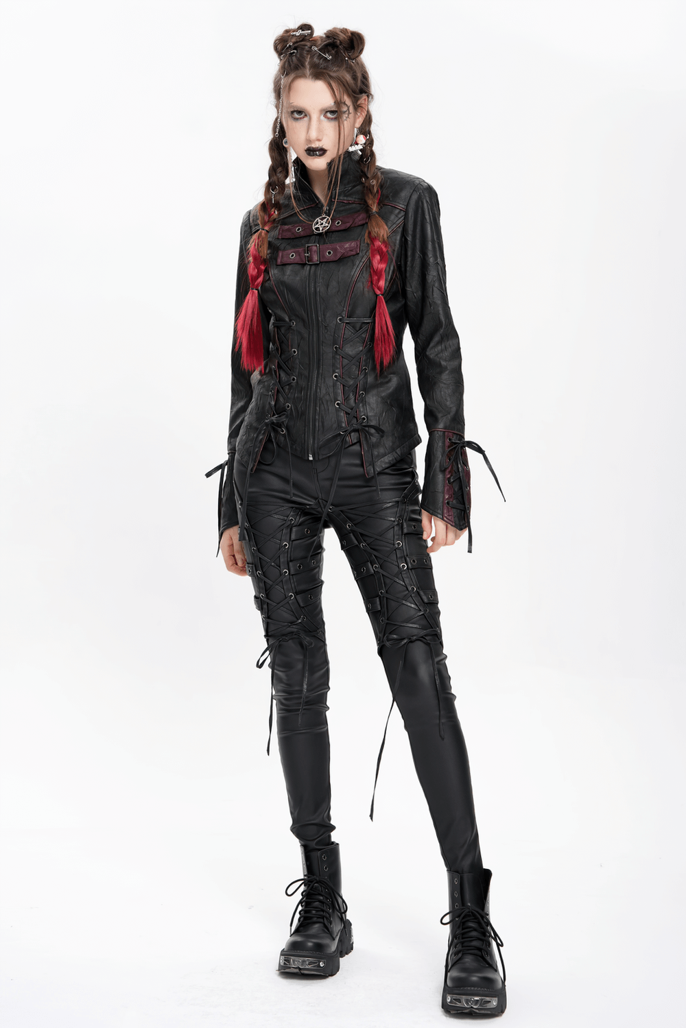 Gothic black faux leather jacket with buckles and lacing, styled for a punk look with red accents and lace-up pants.
