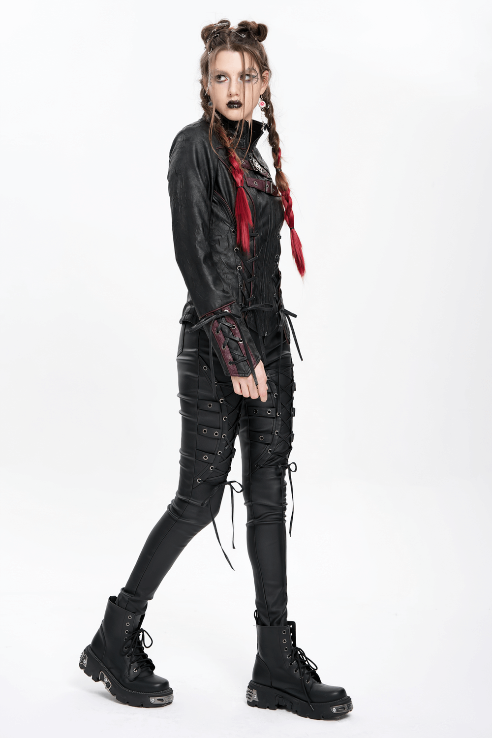 Gothic black faux leather jacket with buckles and lacing, worn by model with braided hair and dark makeup.