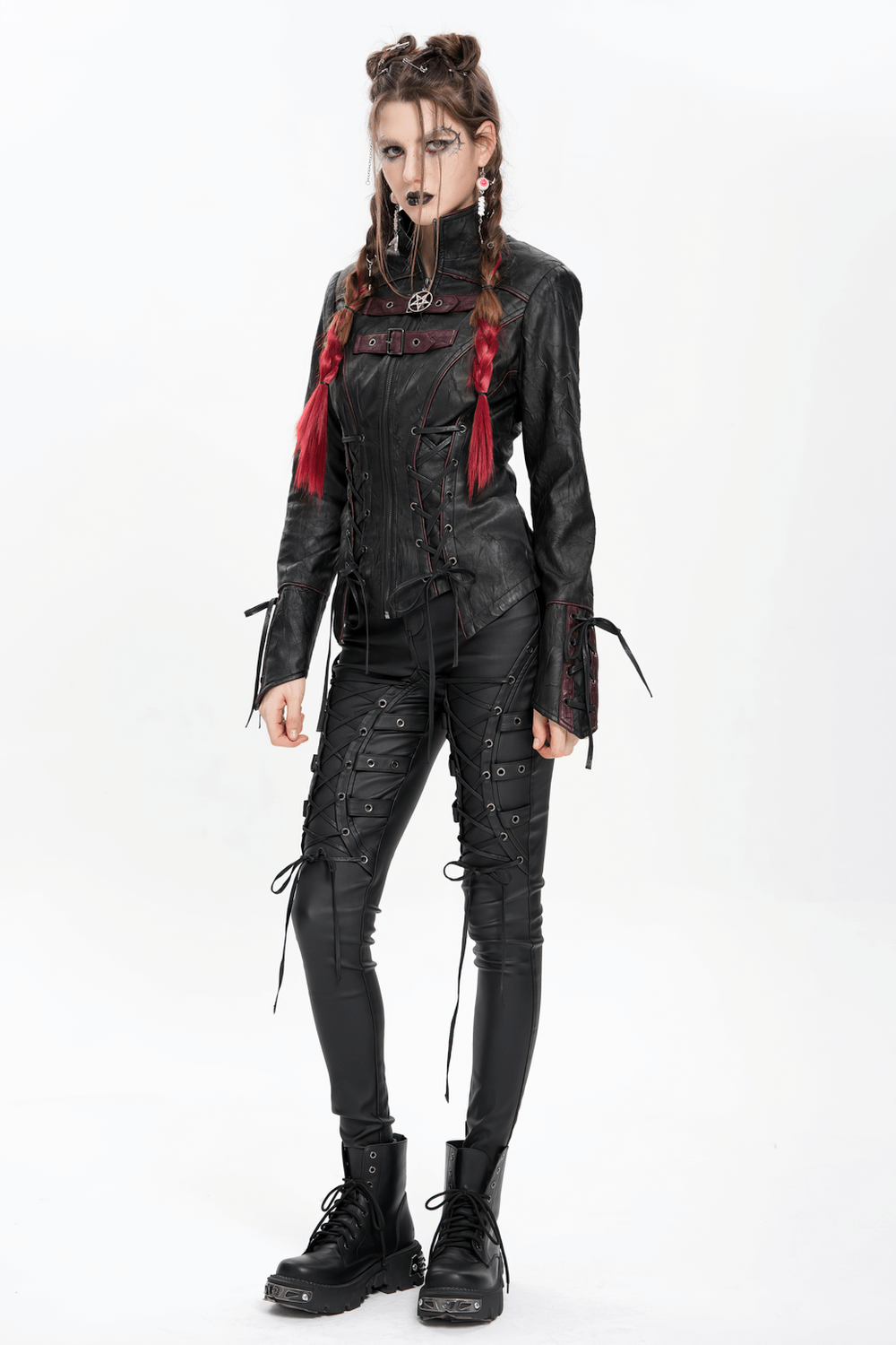 Model wearing Gothic black faux leather jacket with buckles and lacing, paired with lace-up black pants and bold accessories.