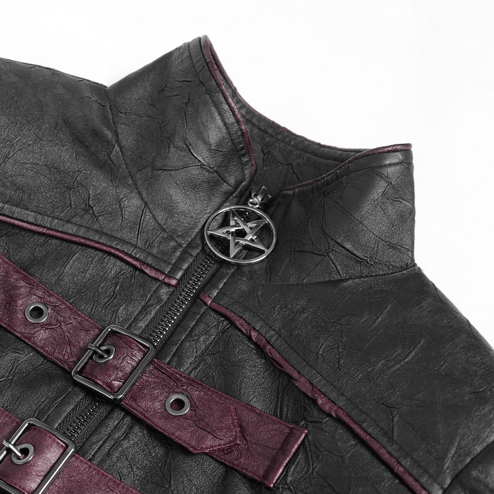 Close-up of gothic black faux leather jacket with buckles, red accents, and pentagram zipper pull.