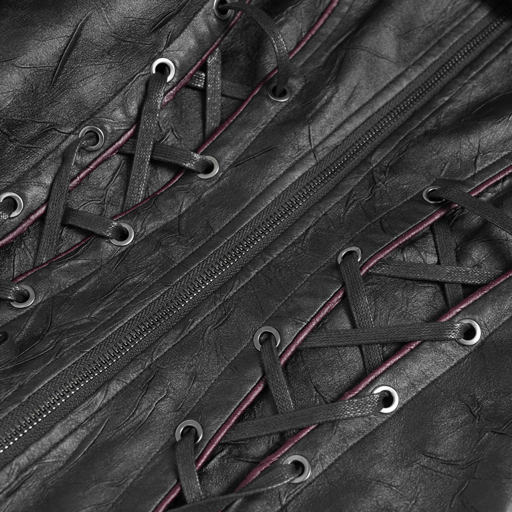 Close-up of gothic black faux leather jacket featuring lace-up details and zipper with deep red accents.
