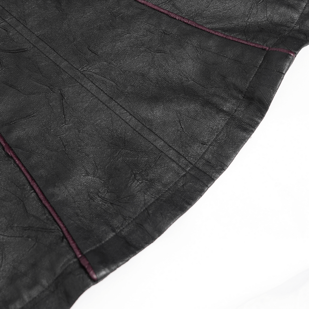 Close-up of gothic black faux leather jacket showcasing deep red accents and tailored seams.