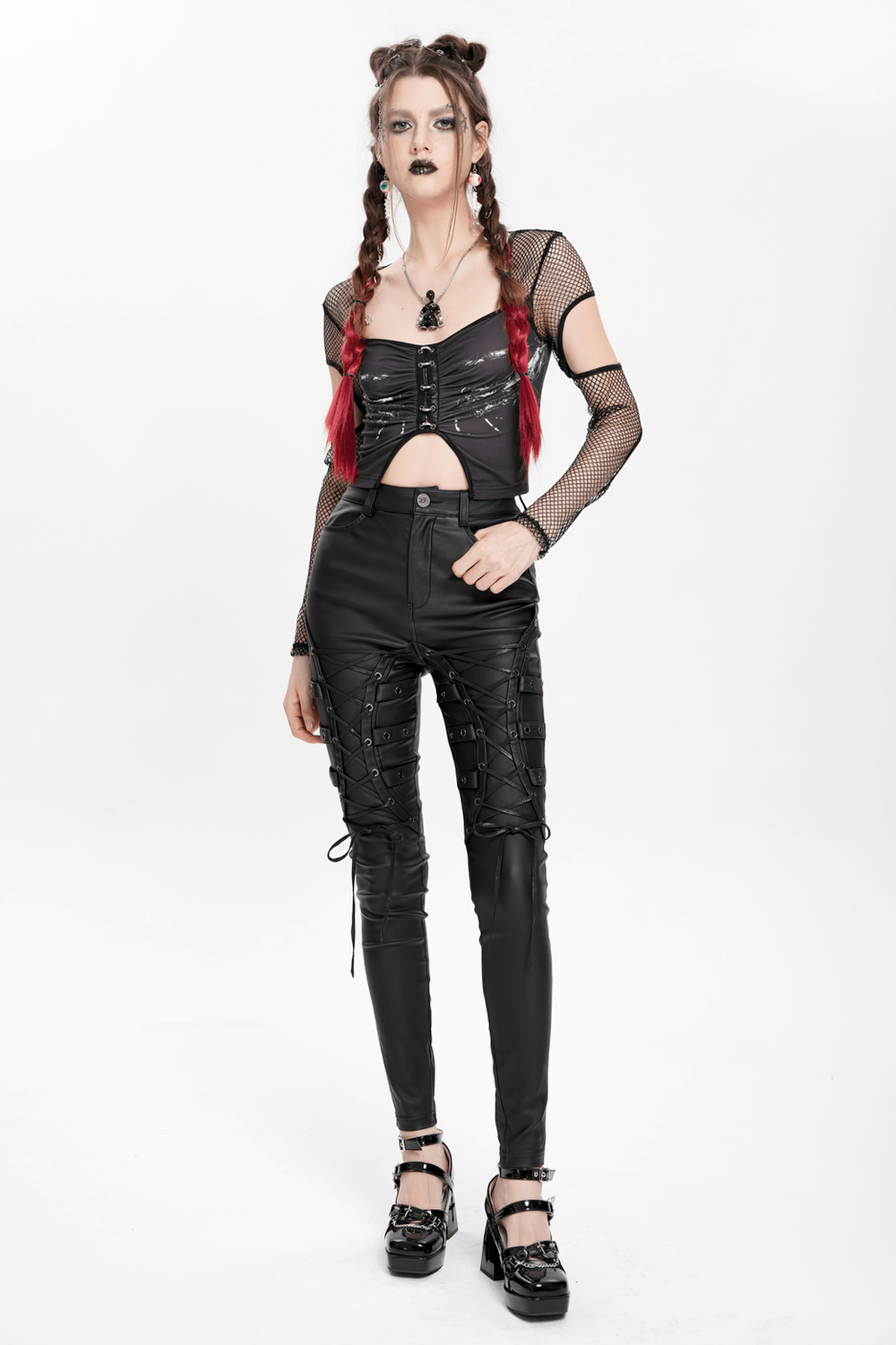 Gothic black faux leather pants with lace-up straps, styled with a mesh top, for a punk rock look.