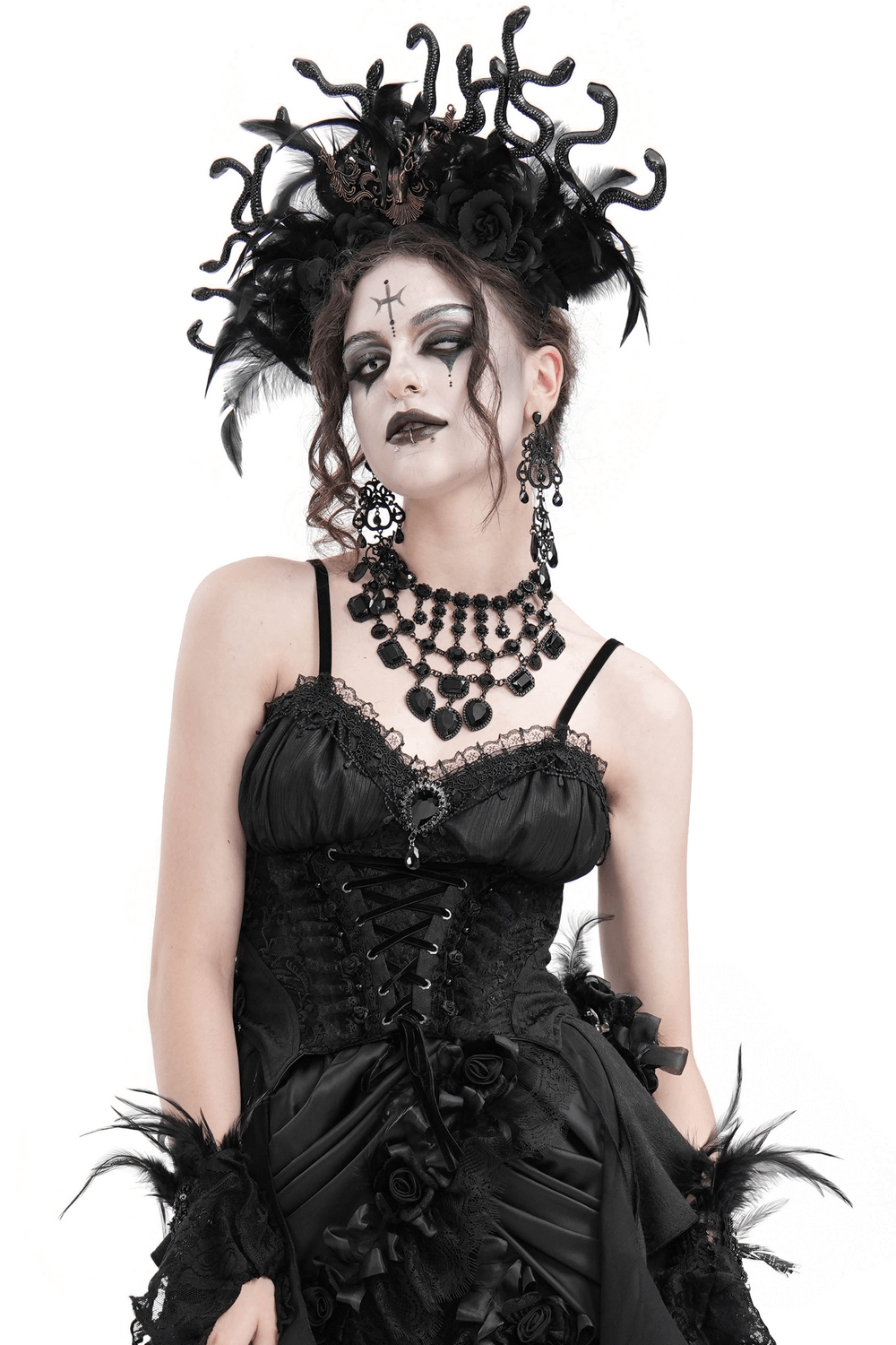 Gothic woman in black feather corset top with lace-up and dramatic headpiece, exuding dark elegance and intricate details.