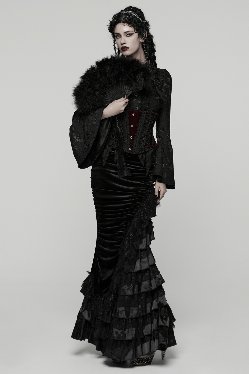 Gothic Black Feather Fan with Tassel and Cross Pendant held by a model in elegant black attire.