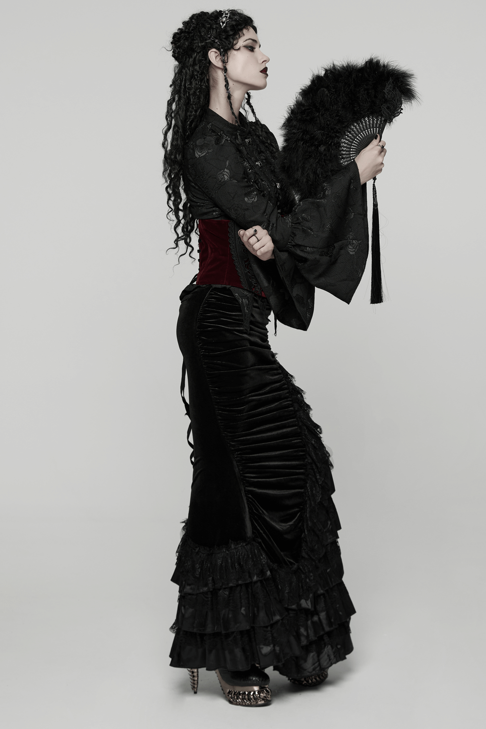 Gothic Black Feather Fan with Tassel and Cross Pendant in elegant dark attire.