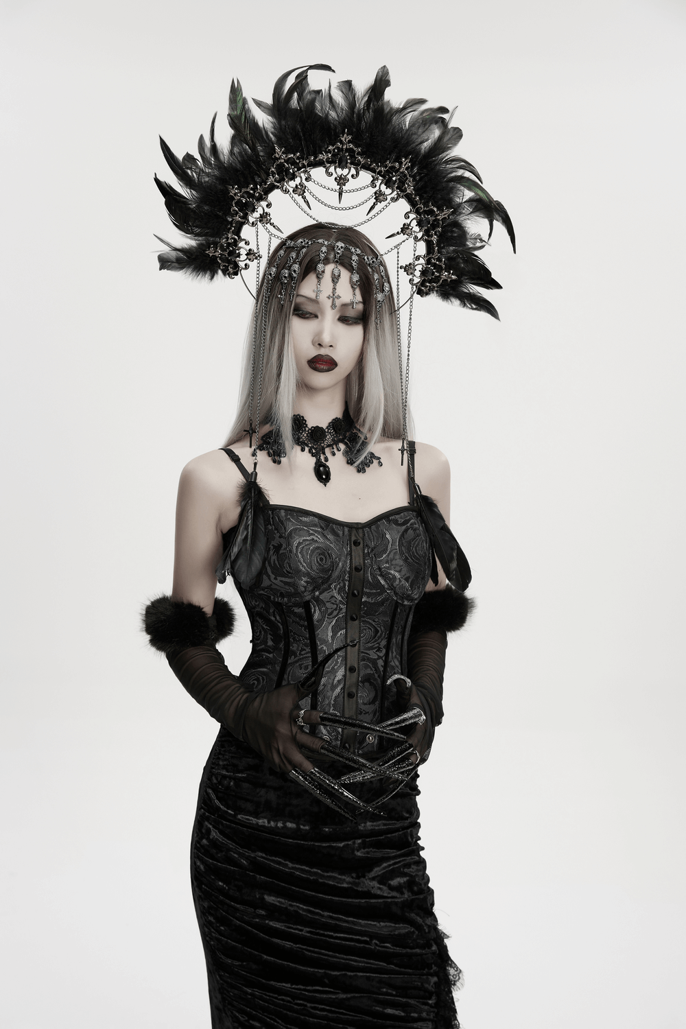 Gothic Black Feather Halo Headdress with Chains elegantly worn by a model in a dark, dramatic outfit.