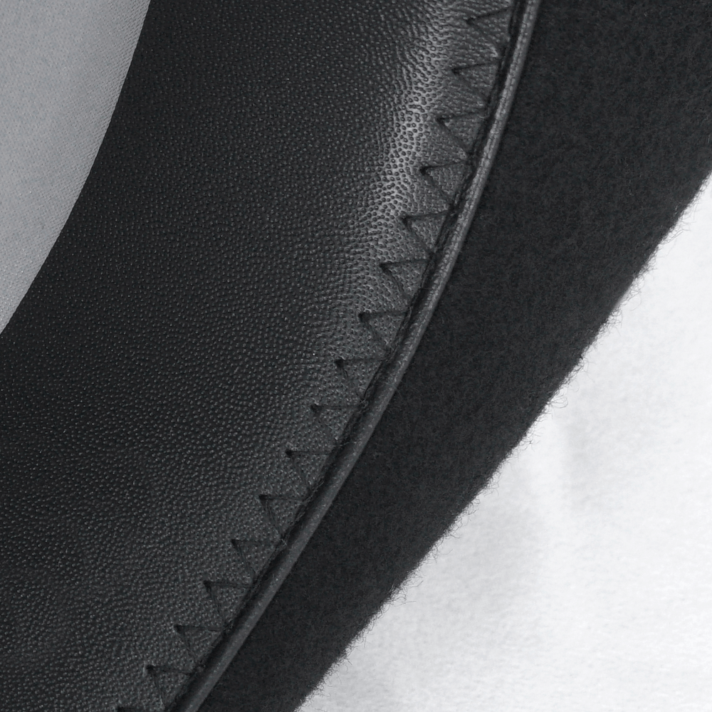 Close-up of the inner lining and stitching of a black feathered gothic top hat.