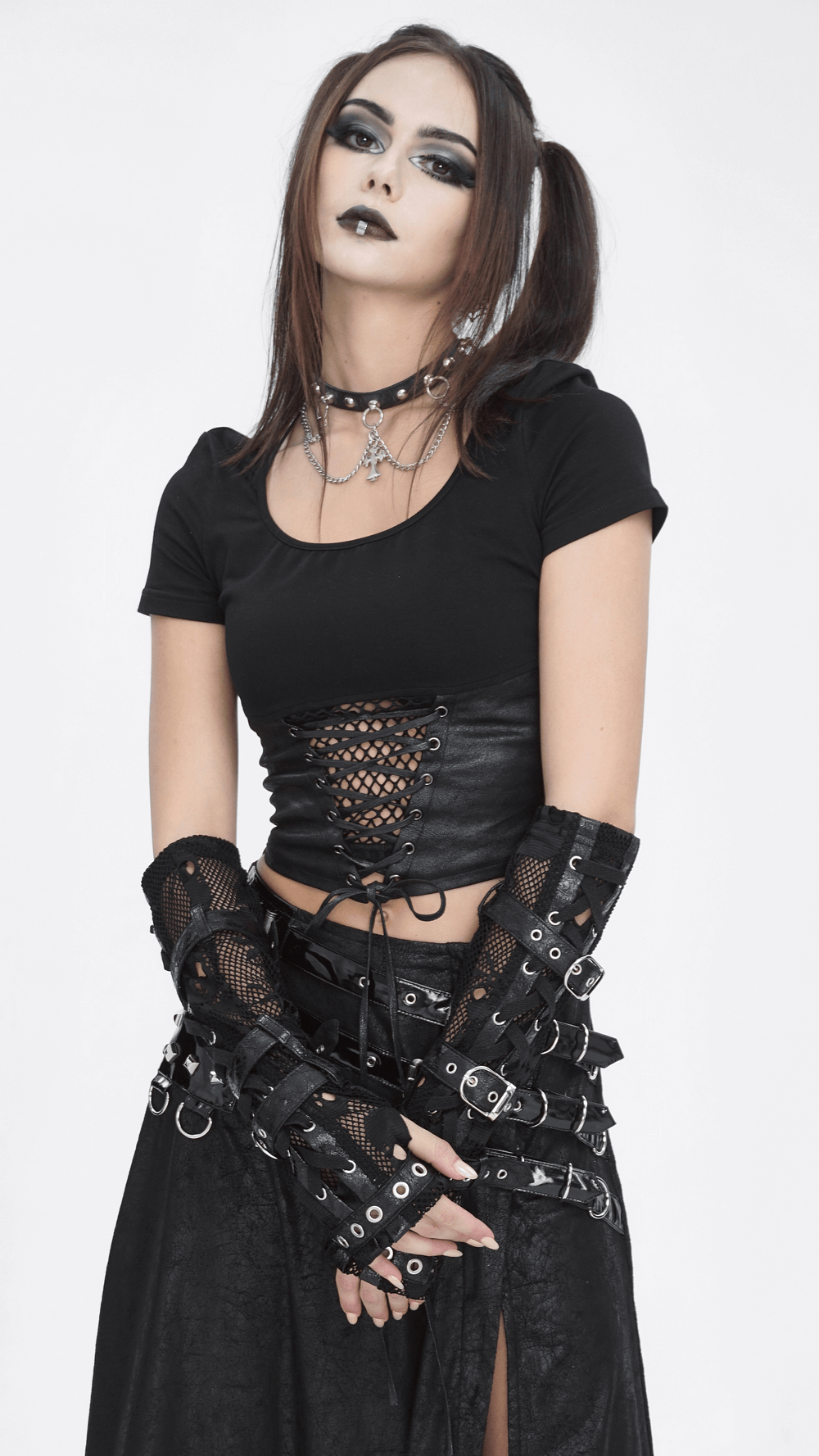 Gothic model showcases punk black fishnet fingerless gloves with buckles, adding edgy style to a black outfit.